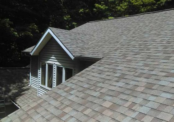 Brand new dark shingles on two story house.